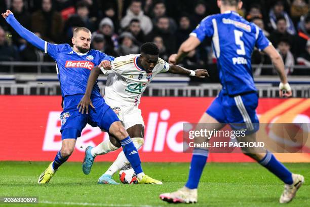 Lyon's Ghanaian forward Ernest Nuamah fights for the ball with Strasbourg's French defender Thomas Delaine during the French Cup quarter final match...