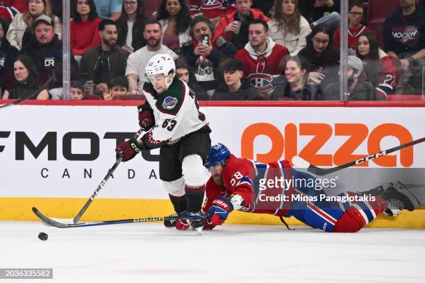 Matias Maccelli of the Arizona Coyotes skates the puck past David Savard of the Montreal Canadiens during the first period at the Bell Centre on...