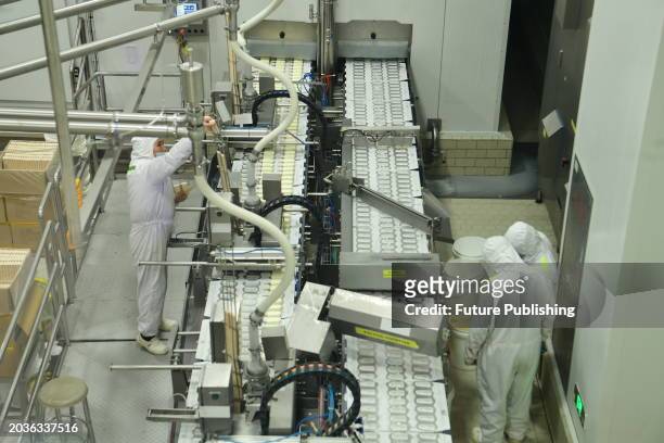 Workers work on the production line at the world's first ice cream "Lighthouse Network" Unilever Wall's production site in Taicang, Jiangsu province,...