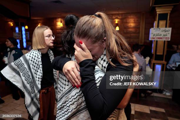 People hug at the Listen to Michigan watch party, a group who asked voters to vote uncommitted instead of for US President Joe Biden in Michigan's US...