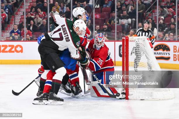 Goaltender Sam Montembeault of the Montreal Canadiens and Nick Bjugstad of the Arizona Coyotes watch the puck during the third period at the Bell...