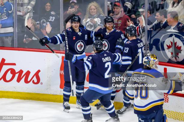 Mark Scheifele, Kyle Connor, Dylan DeMelo and Gabriel Vilardi of the Winnipeg Jets celebrate a first period goal against the St. Louis Blues at the...