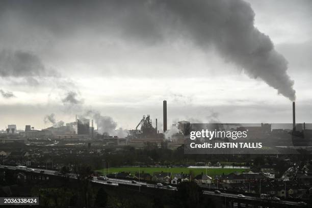 The Tata Steel Port Talbot integrated iron and steel works is pictured in south Wales on February 2, 2024. In the dim light of a pub in the steel...