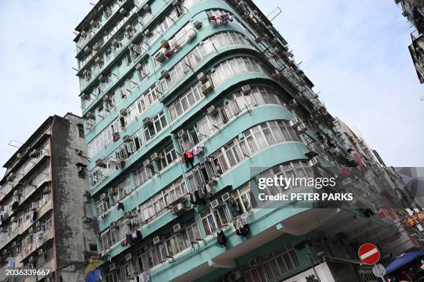 Photo taken on February 27, 2024 shows a view of residential buildings in Kowloon, Hong Kong. Hong Kong has dropped all property market curbs in a...