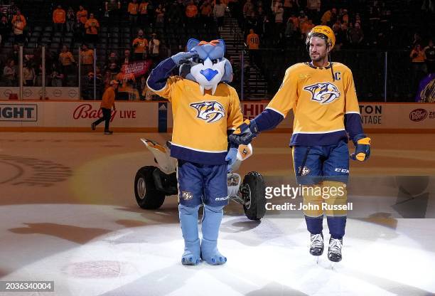 Nashville Predators mascot Gnash salutes team captain Roman Josi after a 4-1 win against the Ottawa Senators during an NHL game at Bridgestone Arena...