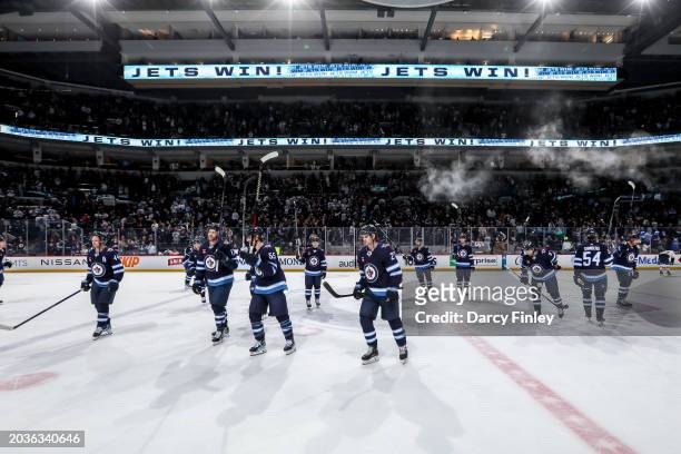 Winnipeg Jets players salute the fans following a 4-2 victory over the St. Louis Blues at the Canada Life Centre on February 27, 2024 in Winnipeg,...
