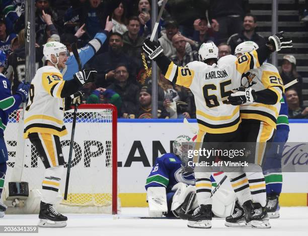 Erik Karlsson of the Pittsburgh Penguins makes an overtime goal on Thatcher Demko of the Vancouver Canucks during their NHL game at Rogers Arena on...