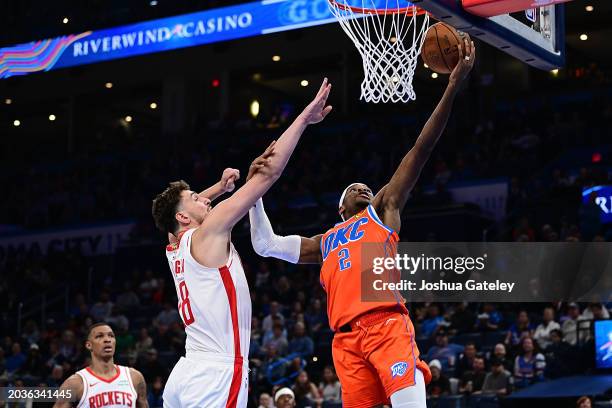 Shai Gilgeous-Alexander of the Oklahoma City Thunder goes up for a layup while being defended by Alperen Sengun of the Houston Rockets during the...