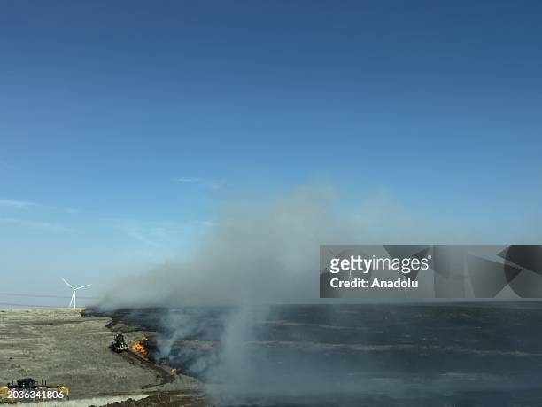 Smoke rises as heavy equipment works to contain the Juliet Pass fire in Armstrong County, Texas, United States on February 27, 2024.