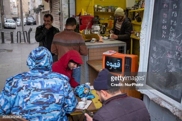 Iranian men are sitting together at an outdoor cafe in southern Tehran, Iran, on February 27 amid the Parliamentary election campaigns. The elections...