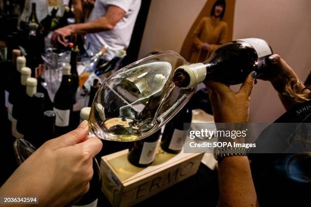 Worker pouring wine into a glass during the Essence of Wine event. Essência do Vinho commemorates its 20th-year milestone at the iconic Palácio da...