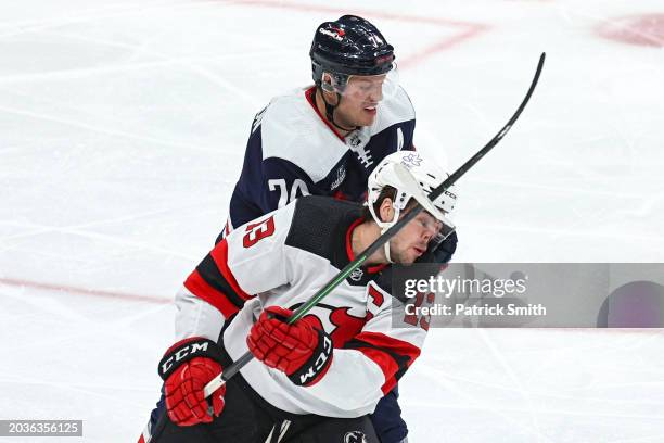 Nico Hischier of the New Jersey Devils is hit in the face by the stick of John Carlson of the Washington Capitals during the second period at Capital...