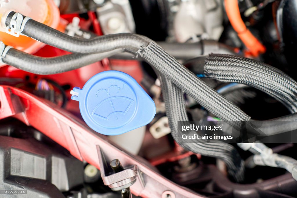 Close-up view of automotive water and filling system water injection for crystals into the car engine, windshield washer fluid reservoir cap. The concept of pre-trip car inspection.