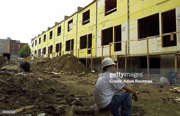 Volunteer takes a brake from building a Habitat for Humanity house May 28, 2003 in Bronx neighborhood of New York City. Habitat for Humanity is...