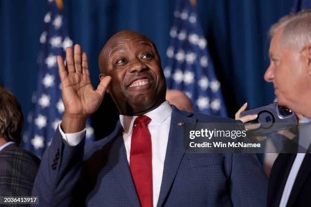 Sen. Tim Scott cheers on Republican presidential candidate and former President Donald Trump speaks during an election night watch party at the State...