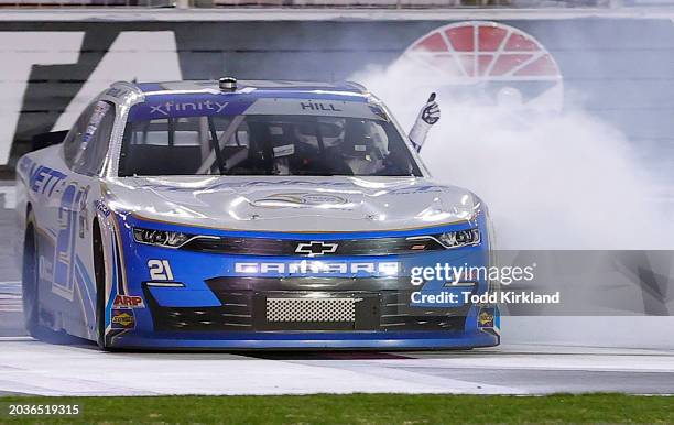 Austin Hill, driver of the Bennett Transportation Chevrolet, celebrates with a burnout after winning the NASCAR Xfinity Series King of Tough 250 at...