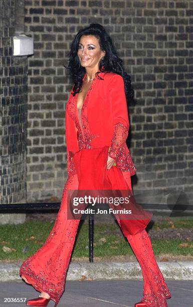 Nancy Dell'Olio wears a red, figure-hugging trouser suit as she arrives at Number 10 Downing Street in October, 2002. Dell'Olio, the girlfriend of...