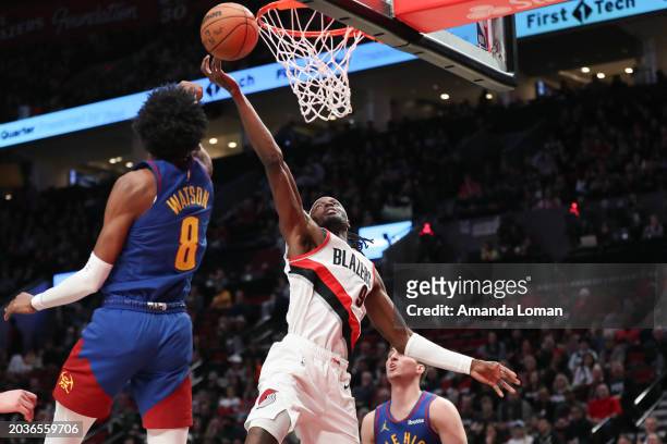 Jerami Grant of the Portland Trail Blazers drives to the basket as Peyton Watson of the Denver Nuggets defends during the first quarter at Moda...