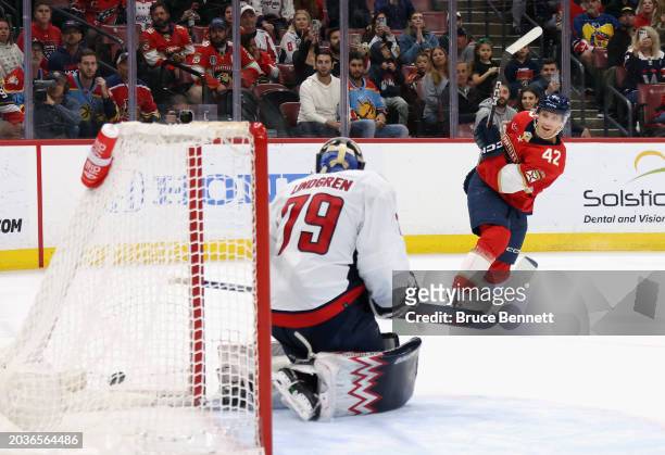 Gustav Forsling of the Florida Panthers scores the game-winning goal in overtime against Charlie Lindgren of the Washington Capitals at Amerant Bank...