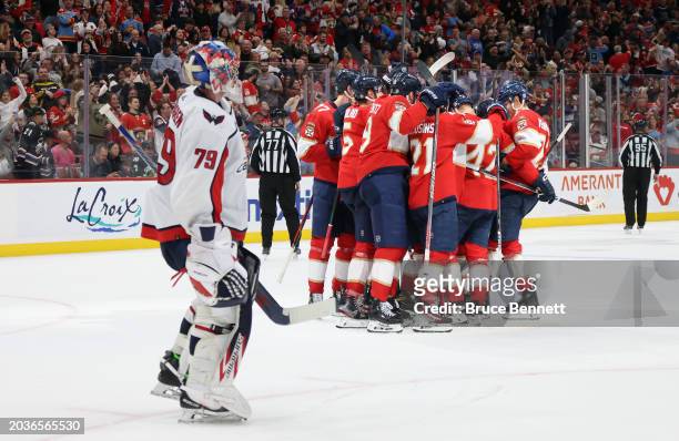 The Florida Panthers celebrate an overtime victory over Charlie Lindgren and the Washington Capitals at Amerant Bank Arena on February 24, 2024 in...