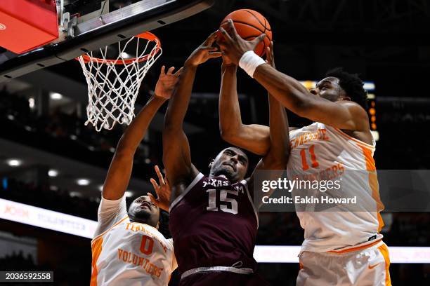 Henry Coleman III of the Texas A&M Aggies, Jonas Aidoo of the Tennessee Volunteers, and Tobe Awaka reach for a rebound in the first half at...