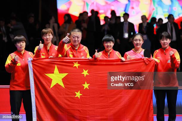 Wang Yidi, Wang Manyu, head coach Ma Lin, Sun Yingsha, Chen Meng and Chen Xingtong pose with Chinese national flag after winning the Final match...