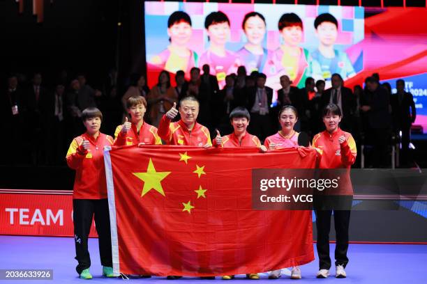 Wang Yidi, Wang Manyu, head coach Ma Lin, Sun Yingsha, Chen Meng and Chen Xingtong pose with Chinese national flag after winning the Final match...