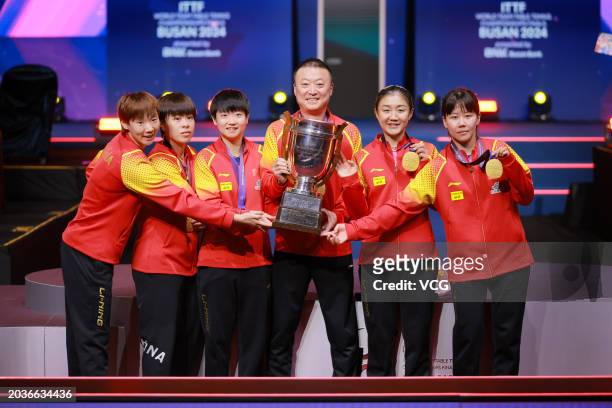 Wang Manyu, Wang Yidi, Sun Yingsha, head coach Ma Lin, Chen Meng and Chen Xingtong pose with trophy and gold medals after winning the Final match...