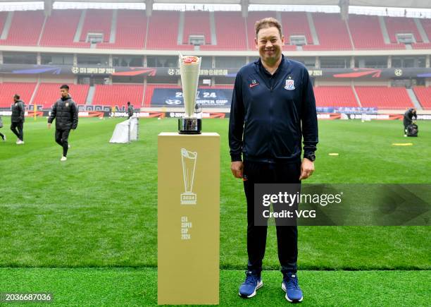 Head coach Leonid Slutsky of Shanghai Shenhua poses beside a trophy ahead of the 2024 Chinese Football Association Super Cup on February 24, 2024 in...