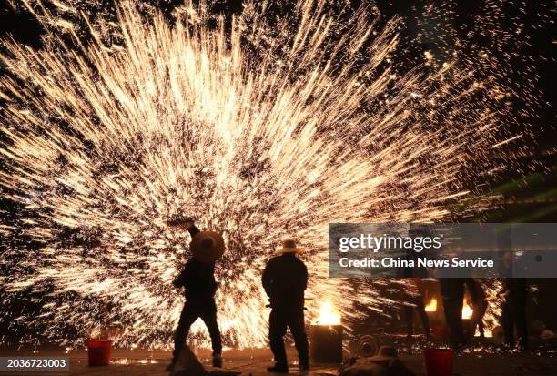 Folk artists stage a molten iron fireworks performance to celebrate the Lantern Festival on February 24, 2024 in Luding, Sichuan Province of China....