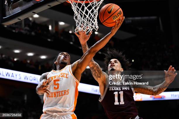 Zakai Zeigler of the Tennessee Volunteers goes up under the basket for two against Andersson Garcia of the Texas A&M Aggies in the second half at...