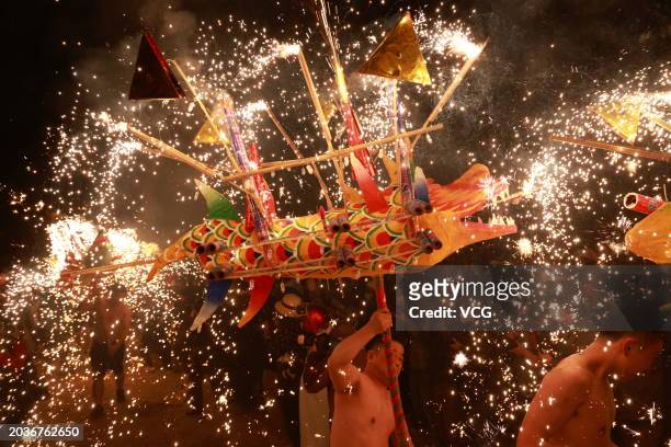 Folk artists perform the Puzhai fire dragon dance to celebrate the Lantern Festival on February 24, 2024 in Meizhou, Guangdong Province of China....