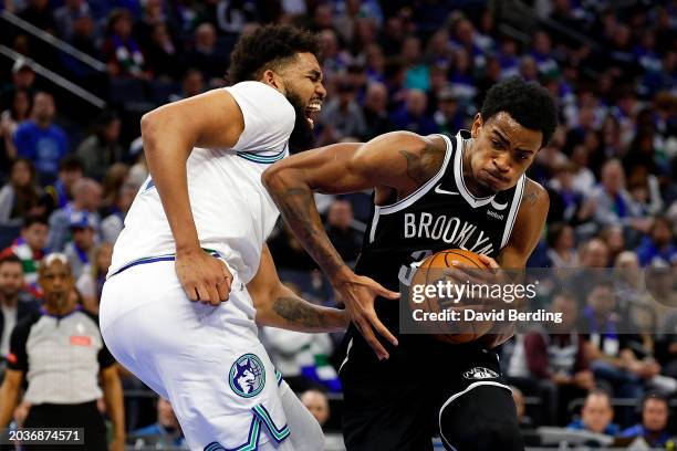 Karl-Anthony Towns of the Minnesota Timberwolves reacts as Nic Claxton of the Brooklyn Nets drives to the basket in the fourth quarter at Target...