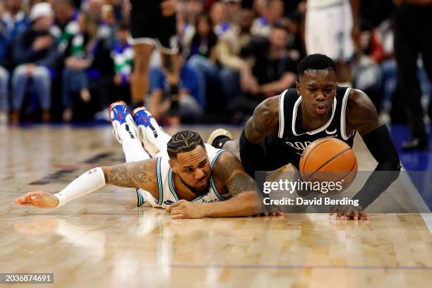 Monte Morris of the Minnesota Timberwolves and Dennis Schroder of the Brooklyn Nets compete for a loose ball in the third quarter at Target Center on...