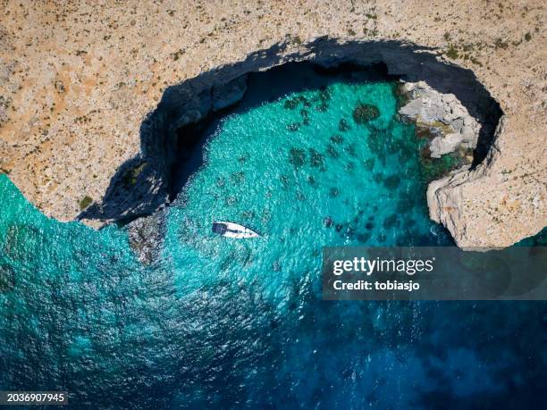 blue lagoon malta: aerial view of tranquil boat - boat deck background stock pictures, royalty-free photos & images