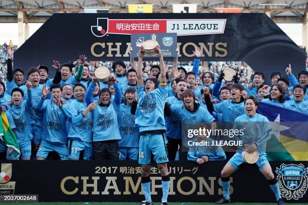 Kengo Nakamura of Kawasaki Frontale lifts the tub imitating the J.League J1 season champions plaque at the award ceremony following the J.League J1...