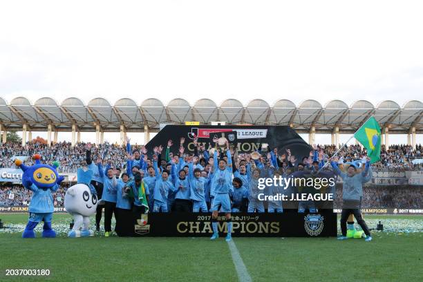 Captain Yu Kobayashi of Kawasaki Frontale lifts the tub imitating the J.League J1 season champions plaque at the award ceremony following the...