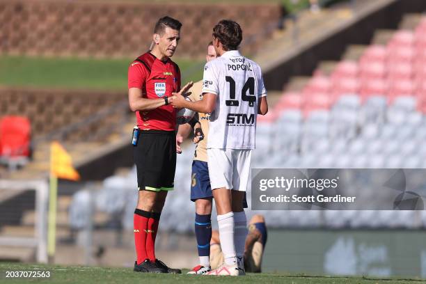 Referee Jonathon Barreiro talks with Kristian Popovic of the Bulls during the A-League Men round 18 match between Newcastle Jets and Macarthur FC at...