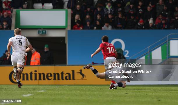 Portugal's Manual Vareiro breaks clear from England A's Caolan Englefield to score his sides only try during the rugby international match between...