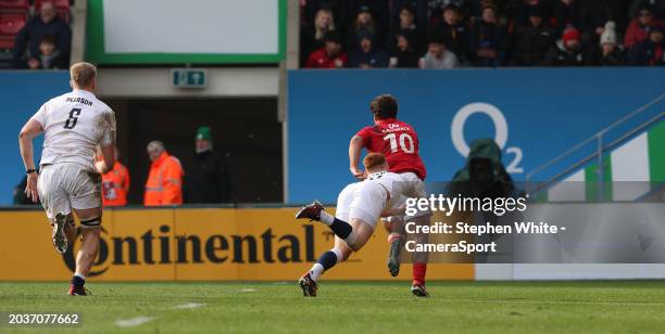 Portugal's Manual Vareiro breaks clear from England A's Caolan Englefield to score his sides only try during the rugby international match between...