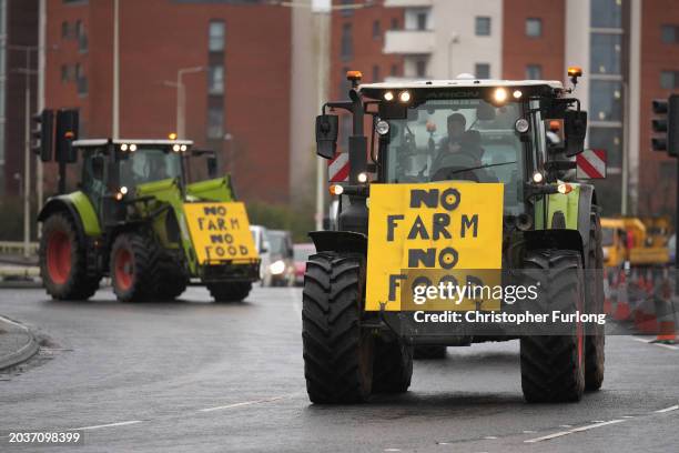 Tractors with signs reading "No Farm No Food" arrive at a holding area at the Queens Gate traffic Roundabout on February 28, 2024 in Cardiff, Wales....