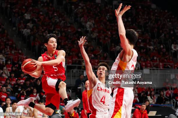 Yuki Kawamura of Japan passes the ball under pressure from Jiwei Zhao and Abudushalamu Abudurexiti of China during the FIBA Basketball Asia Cup...