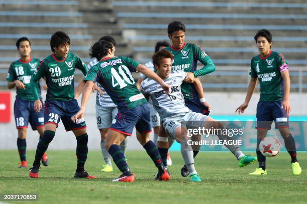 Masaya Yuma of Blaublitz Akita competes for the ball against Gainare Tottori defense during the J.League J3 match between Gainare Tottori and...