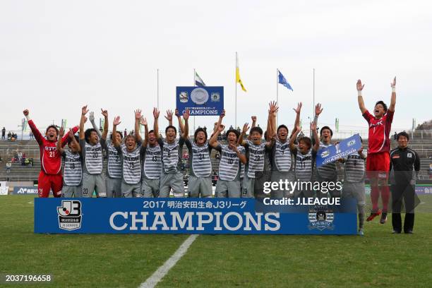 Captain Naoyuki Yamada of Blaublitz Akita lifts the panel of the J.League J3 Champions plaque at the award ceremony following the J.League J3 match...