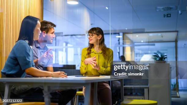 business people sitting in office - three people stock pictures, royalty-free photos & images
