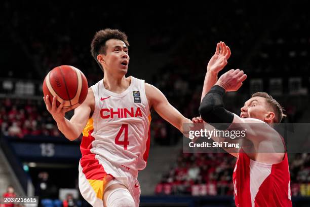 Jiwei Zhao of China drives against Joshua Hawkinson of Japan during the FIBA Asia Cup qualifier Group C game between Japan and China at Ariake...