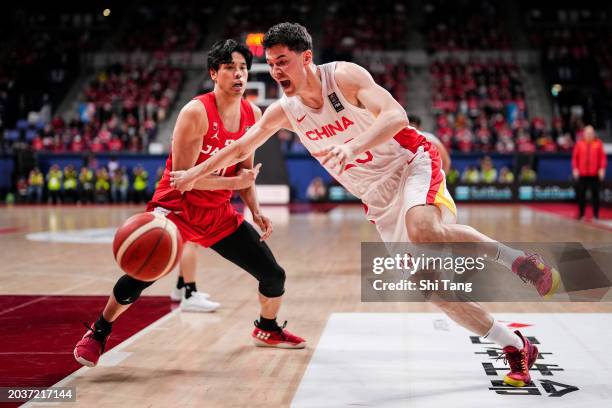 Abudushalamu Abudurexiti of China drives against Hirotaka Yoshii of Japan during the FIBA Asia Cup qualifier Group C game between Japan and China at...