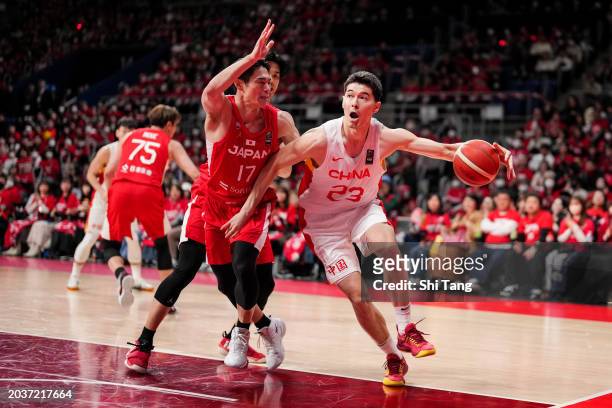 Abudushalamu Abudurexiti of China drives against Yutaroh Suda of Japan during the FIBA Asia Cup qualifier Group C game between Japan and China at...
