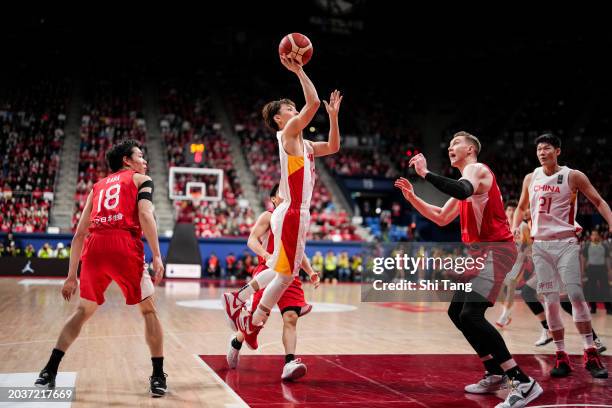 Jie Xu of China shoots against Joshua Hawkinson of Japan during the FIBA Asia Cup qualifier Group C game between Japan and China at Ariake Coliseum...