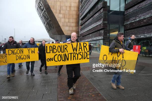 Farmers carrying placards protest outside the Senedd on February 28, 2024 in Cardiff, Wales. Following peaceful demonstrations in Wrexham, Rhyl, Old...